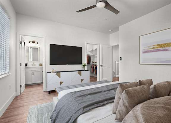 a bedroom with a large bed and a ceiling fan