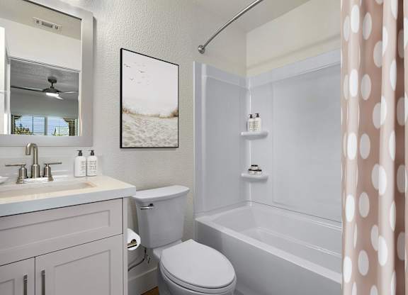 a white bathroom with a shower curtain and a toilet