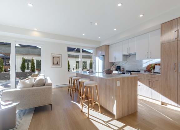A modern kitchen with wooden cabinets and a large island in Hillcrest Ave located in Abbotsford, BC