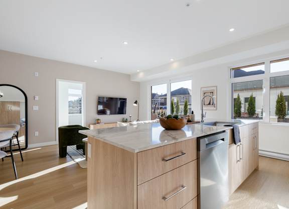 A modern kitchen with wooden cabinets and a large island in Hillcrest Ave located in Abbotsford, BC