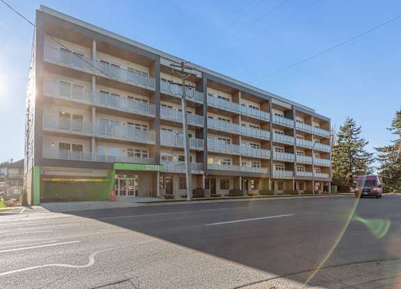 A large apartment building Hillcrest Ave, with a green awning located in Abbotsford, BC