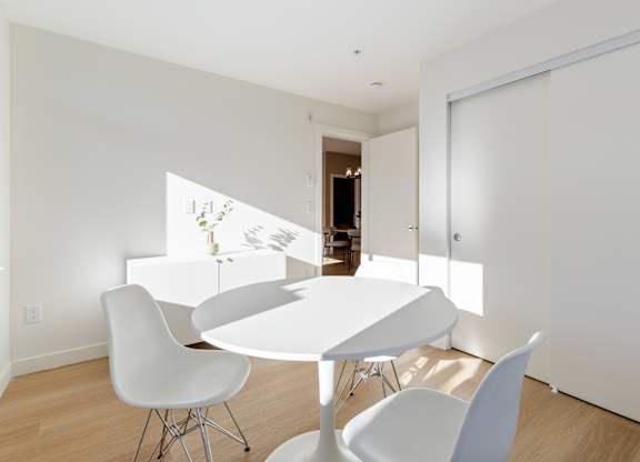 A white dining table with four chairs in a room in Hillcrest Ave located in Abbotsford, BC