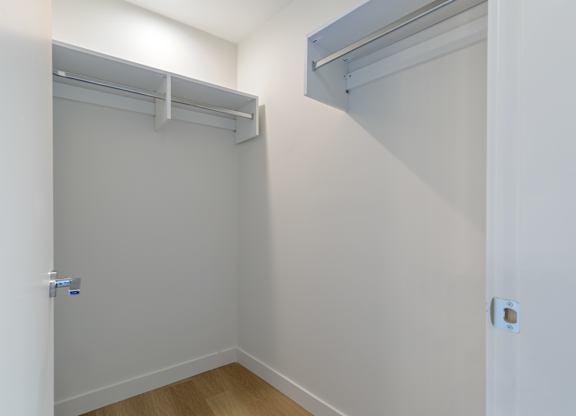 A white closet with a sliding door and a shelf above it in Hillcrest Ave located in Abbotsford, BC