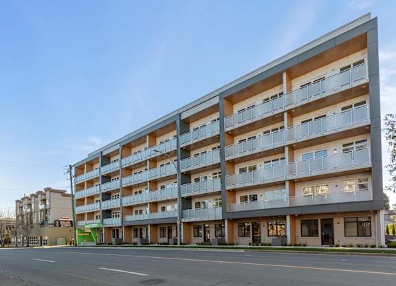 Image of a modern multi-story residential building with balconies and large windows at Hillcrest Ave located in Abbotsford, BC
