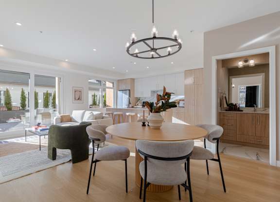 A modern dining room with a round table and chairs in Hillcrest Ave located in Abbotsford, BC