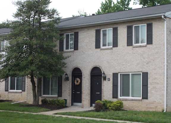 A house with a black door and window shutters.