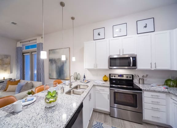 Modern kitchen with white cabinets and island at Ciel Luxury Apartments, Jacksonville, 32246
