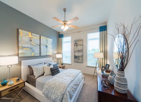 Modern bedroom with gray accent wall at Ciel Luxury Apartments, Florida