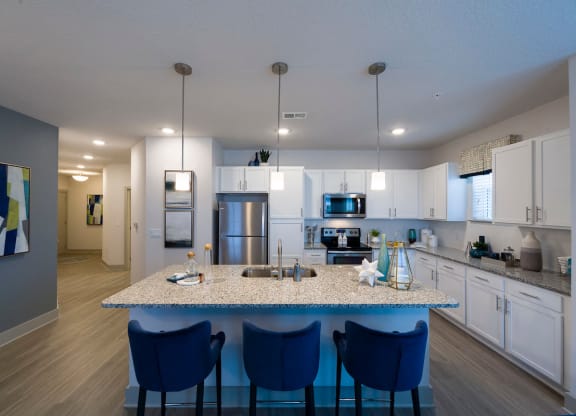 Kitchen island with blue bar stools at Ciel Luxury Apartments, Jacksonville, FL