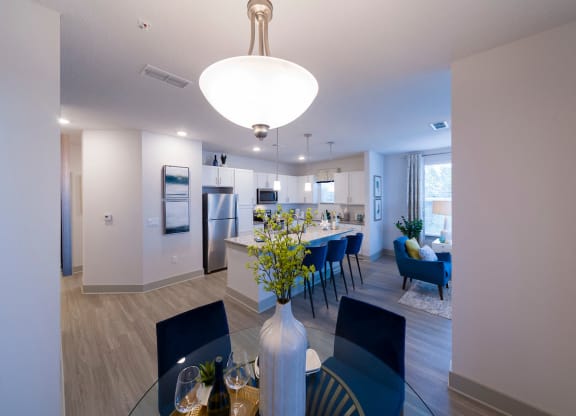 Open dining room with glass table at Ciel Luxury Apartments, Jacksonville, Florida