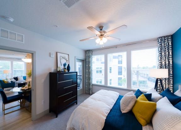 Bright bedroom with blue accent pillow arrangement at Ciel Luxury Apartments, Florida, 32246
