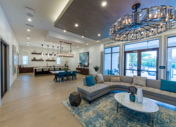 Spacious open concept living area with curved sectional at Ciel Luxury Apartments, Jacksonville, FL 32246