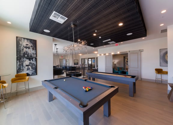 Game room with pool tables and modern lighting at Ciel Luxury Apartments, Florida, 32246