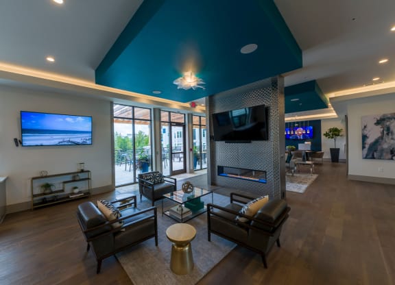 Modern clubhouse with fireplace and teal ceiling design at Ciel Luxury Apartments, Florida, 32246
