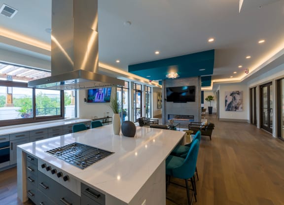 Modern kitchen island with gas cooktop and hood at Ciel Luxury Apartments, Jacksonville, FL