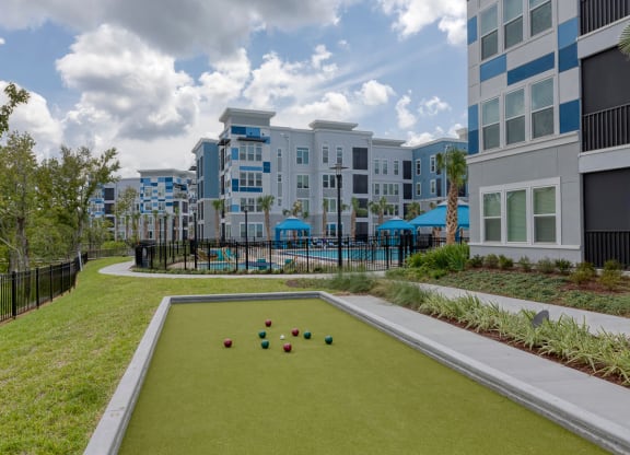 Bocce ball court with colorful balls on green surface at Ciel Luxury Apartments, Florida