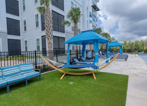 Hammock on artificial turf with poolside cabanas at Ciel Luxury Apartments, Jacksonville, FL 32246