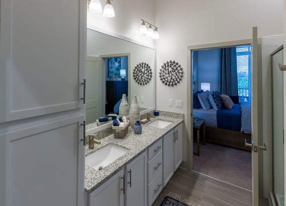 Modern bathroom with double vanity and granite countertop at Ciel Luxury Apartments, Florida, 32246