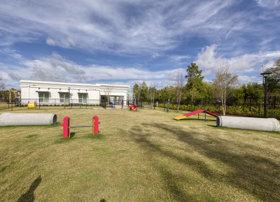 Dog agility course with concrete tunnels and obstacles at Ciel Luxury Apartments, Jacksonville, Florida