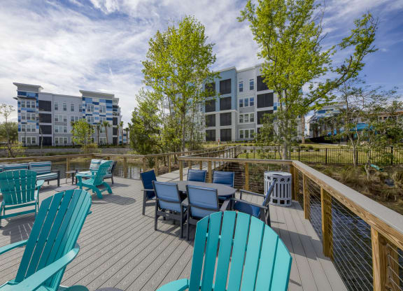 Waterfront deck with outdoor furniture and apartment views at Ciel Luxury Apartments, Jacksonville, Florida