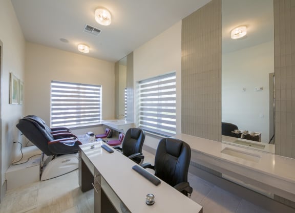 Hair salon styling station with modern chairs and mirrors at Ciel Luxury Apartments, Jacksonville