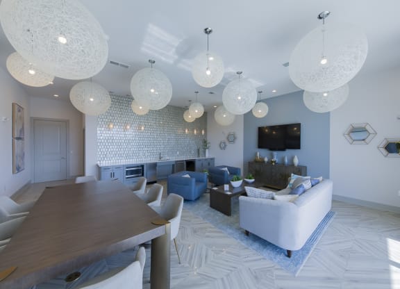 Modern living room with spherical pendant lights at Ciel Luxury Apartments, Jacksonville