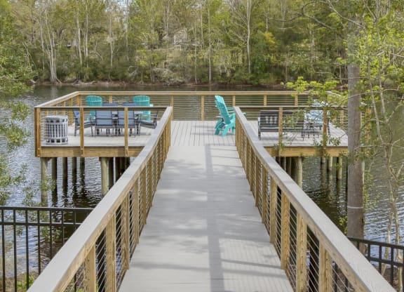 Waterfront boardwalk leading to lakeside deck with seating at Ciel Luxury Apartments, Jacksonville