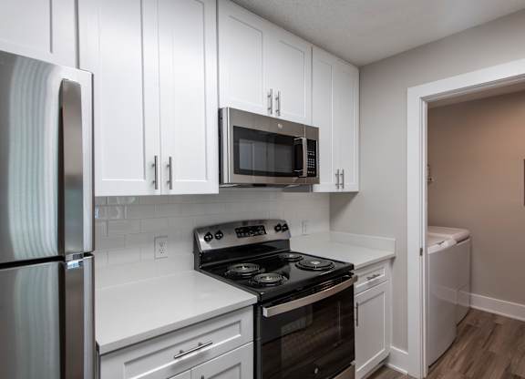 Dobbins Hill kitchen with white cabinets and a black stove top oven.