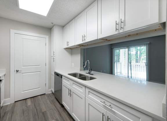 Dobbins Hill kitchen with white cabinets and a window.