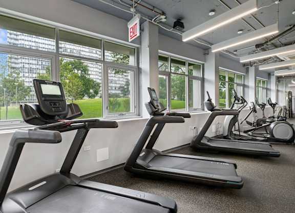 A gym with treadmills and exercise equipment.