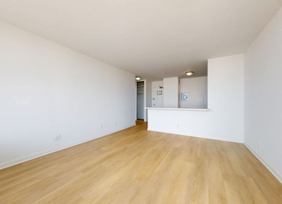 A room with wooden floors and white walls.