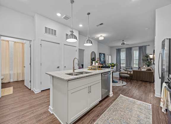 A modern kitchen with a large island and pendant lights.at Address East End, North Carolina
