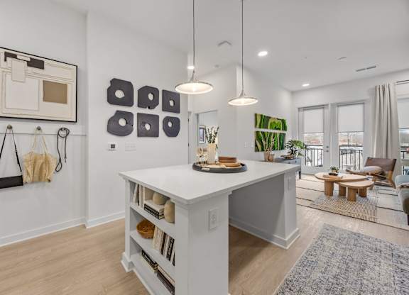 A white kitchen island with a wooden top and shelves below it.at Adler Montford Park + Drexel Townes, Charlotte, NC, 28209