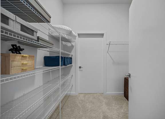 A white pantry with a door and shelves.at Address East End, Raleigh, 27610