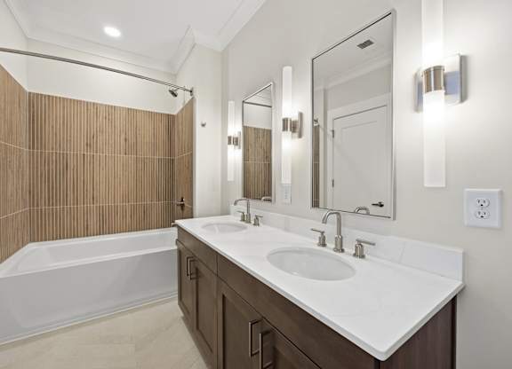 A bathroom with a white sink and a wooden wall.