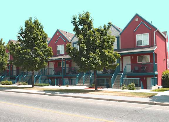 A row of red houses with blue staircases.