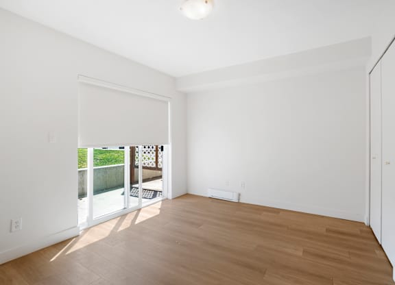 A room with a wooden floor and white walls.
