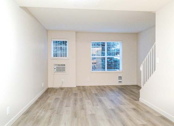 A room with a window and a staircase.