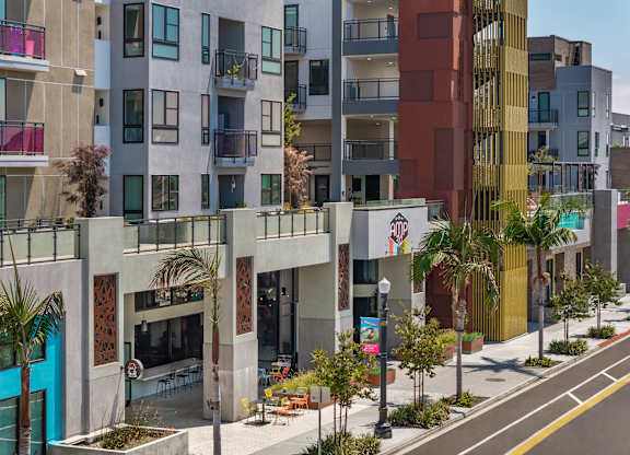 Contemporary mixed use building with street level retail at AMP 30 Apartments, California