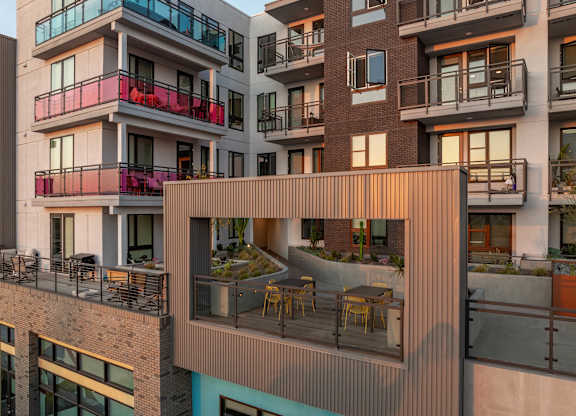 Rooftop terrace with dining area and greenery at AMP 30 Apartments, San Diego, CA 92116