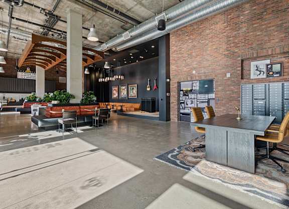 Industrial style lobby with exposed brick and seating at AMP 30 Apartments, San Diego, CA