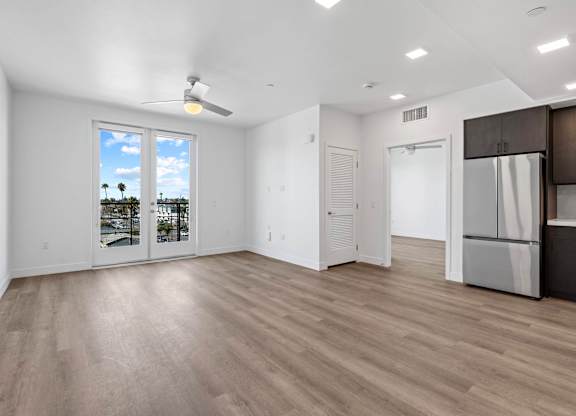 Open concept living room with balcony access at AMP 30 Apartments, San Diego, 92116