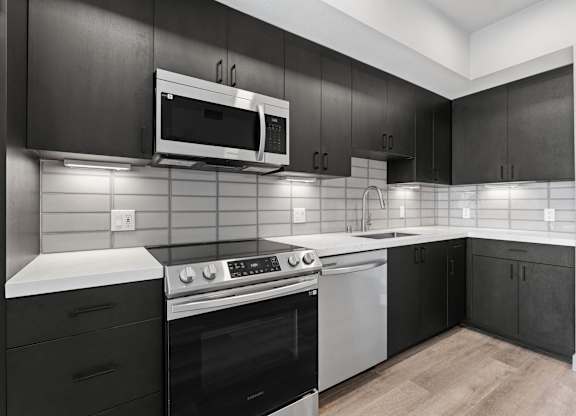 Contemporary kitchen with white subway tile backsplash at AMP 30 Apartments, California