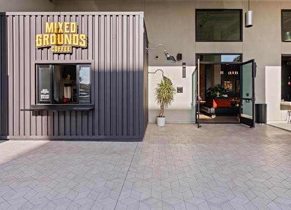 Coffee kiosk and community courtyard entrance at AMP 30 Apartments, California