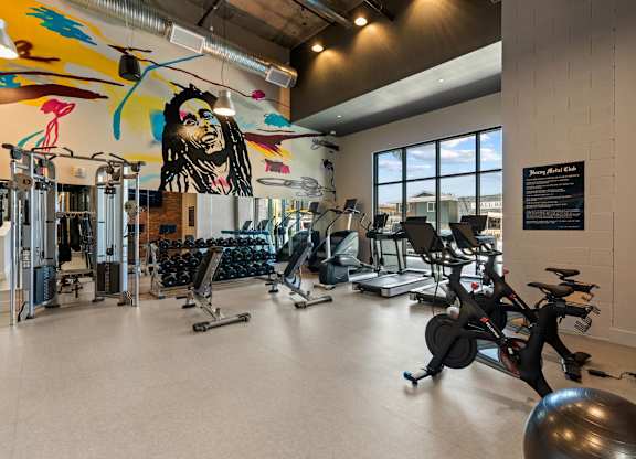 Fitness center with colorful mural and exercise equipment at AMP 30 Apartments, California, 92116