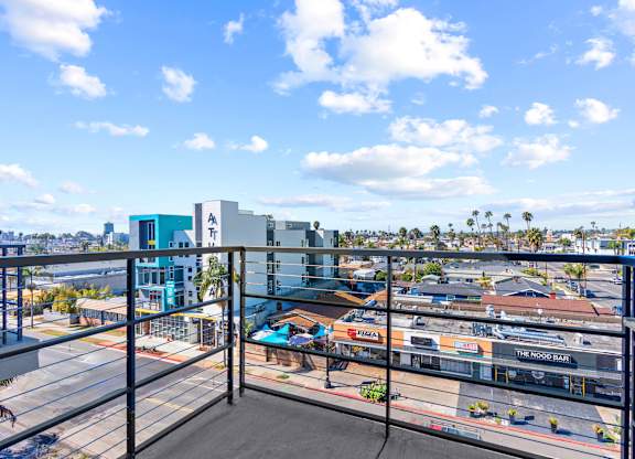 Balcony view overlooking urban neighborhood and palm trees at AMP 30 Apartments, California