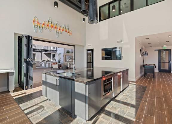 Open kitchen with high ceilings and island at AMP 30 Apartments, San Diego