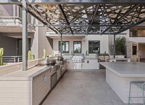 Outdoor grilling station with decorative overhead canopy at AMP 30 Apartments, San Diego, California