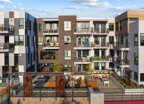 Interior courtyard with multiple balconies and shared amenity space at AMP 30 Apartments, San Diego, CA 92116