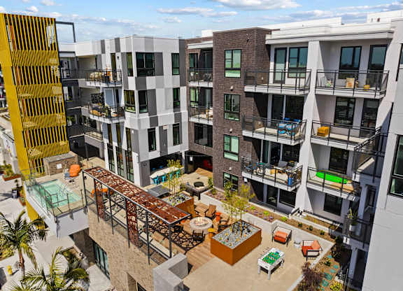 Central courtyard with pergola and communal amenities at AMP 30 Apartments, San Diego, CA